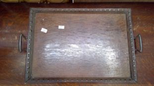 Antique oak tray with handles and carved decoration.