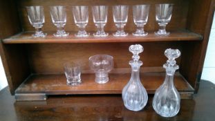 Seven crystal glasses, crystal tumblers, crystal bowl on stem foot, and a pair of decanters.