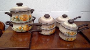 A set of Stahlenmail enamel saucepans and casserole pots.