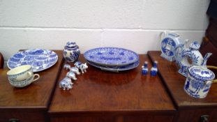 A mix of blue and white decorated china. Includes a pair of teapots, a set of animals etc.