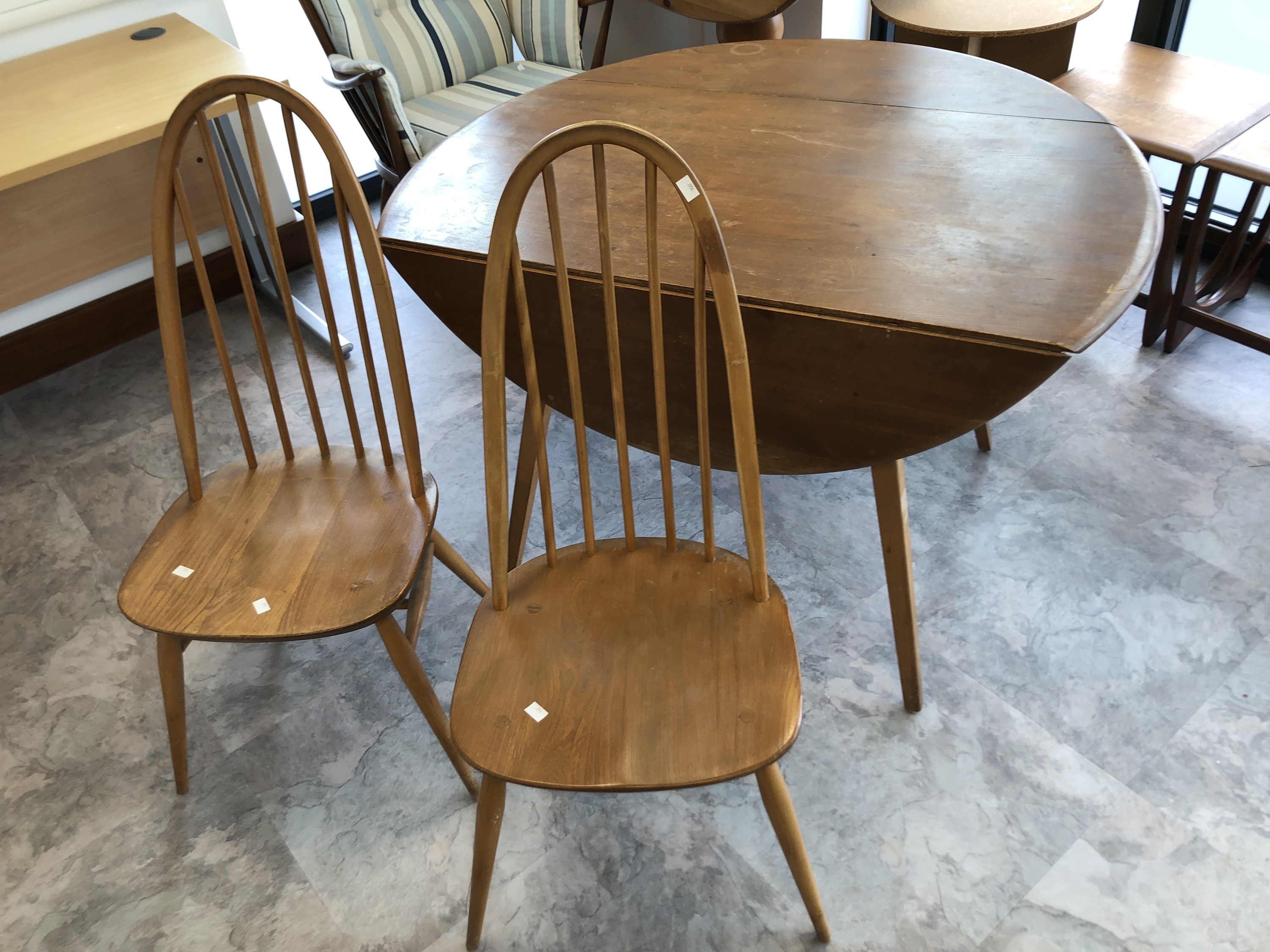 Ercol drop leaf table, height 71cm width 114cm depth 63cm, and a matching pair of Ercol chairs.