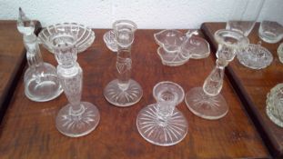 Crystal candlestick holders along with other crystal and glass pieces.