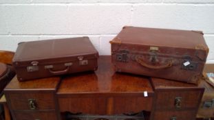 A vintage suitcase made by 'Vulcan'. Comes with one other vintage suitcase.