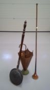 Brass and copper umbrella stand, copper and brass coaching horn, and a copper warming pan.