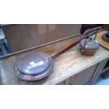Antique copper warming pan and copper kettle.
