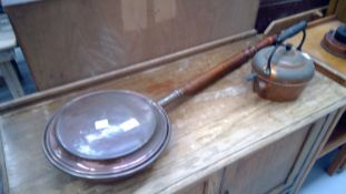 Antique copper warming pan and copper kettle.