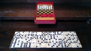 Twentyeight bone and ebony dominoes, and a travel chess set.