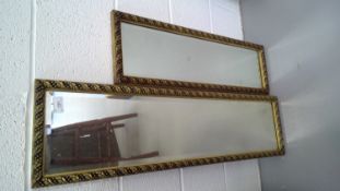 Two mirrors with a foliate motif frame.