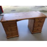 A modern pine desk, height 72cm, width 134cm, depth 56cm.