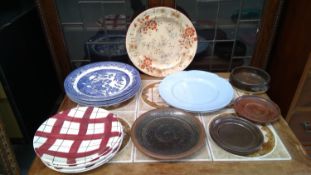 Four stoneware dishes, along with a range of glassware and ceramics.