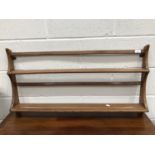 An Ercol hanging plate rack, height 50cm, width 95cm.