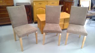 Three modern dining chairs with suede style upholstery