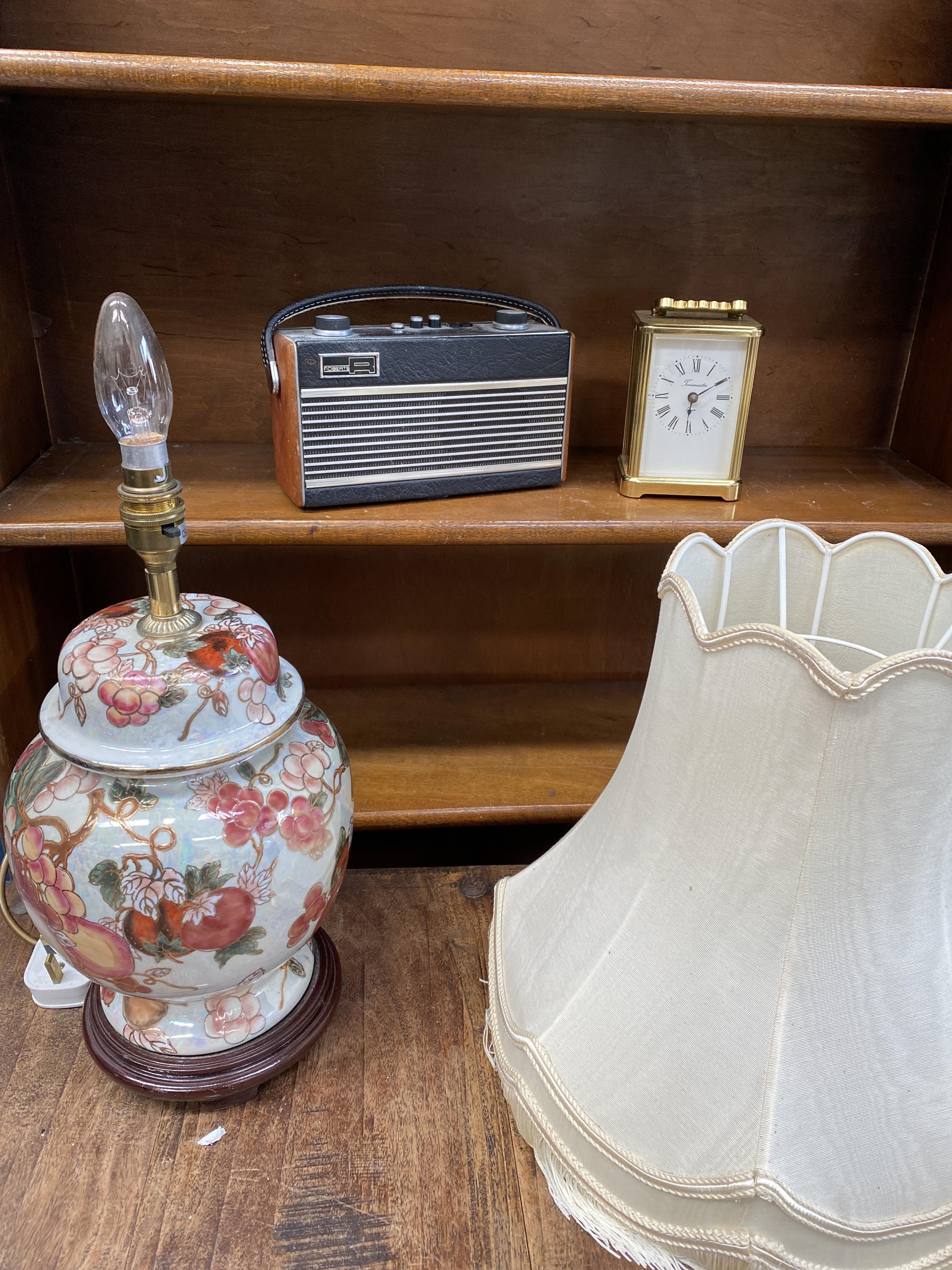 A portable 'Roberts' radio, a ceramic lamp and a modern carriage clock.