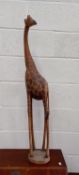 A charming solid wood African giraffe, standing 113cm tall.