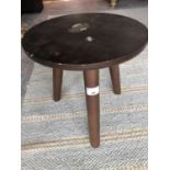 A hardwood stool, the circular top on three legs, height 32cm, diameter 32cm.