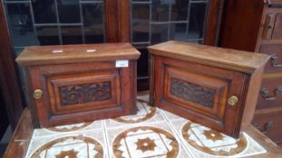 A pair of carved oak wooden boxes.