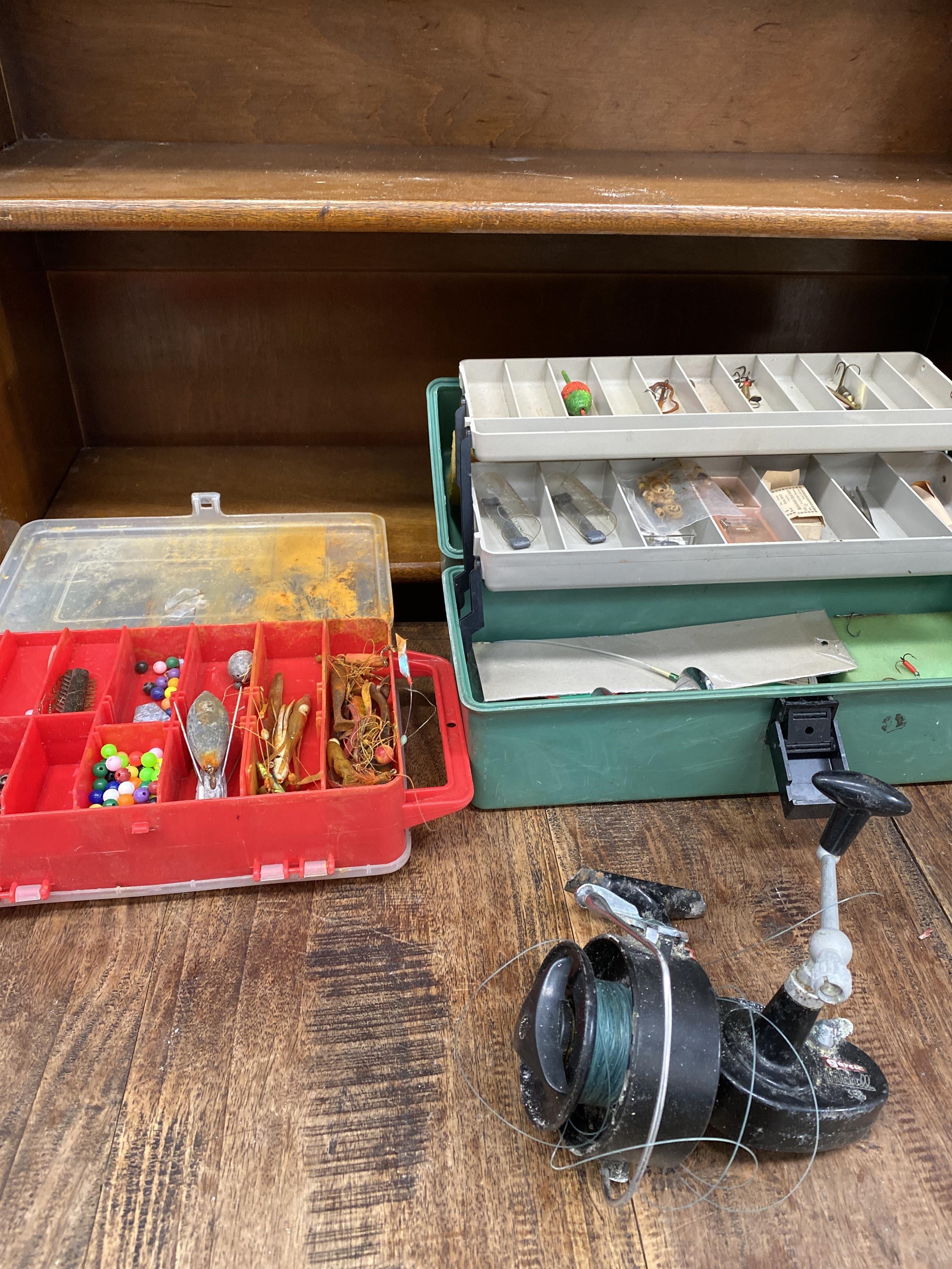 Two tackle boxes and a fishing reel.