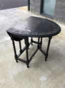 A 1920's oak barley twist gateleg dining table, with an oval carved top, height 74cm, width 76cm,