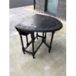 A 1920's oak barley twist gateleg dining table, with an oval carved top, height 74cm, width 76cm,