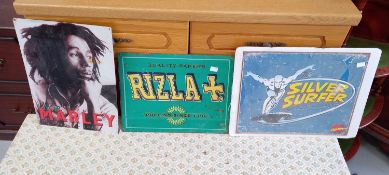 A vintage Rizla sign, a modern 'Silver Surfer' metal sign and a Bob Marley sign.