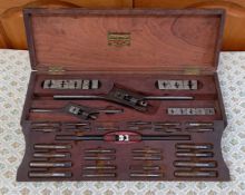 Lehmann, Archer & Lane Ltd die stocks in an attractive woden case, with maker's label to the