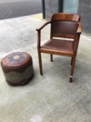 Tub armchair with leather back and seat, and a vintage leather poufe.