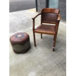 Tub armchair with leather back and seat, and a vintage leather poufe.