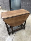 Early twentieth century oak drop leaf table with barley twist legs, height 72cm width 75cm depth