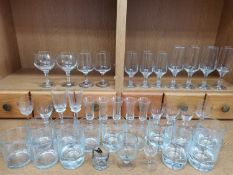 Large collection of glasses and a selection of uranium, cranberry and other coloured glassware.