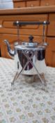 A silver plated spirit kettle with stand and wood-turned handle.