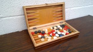 Box of vintage brass darts and a set of backgammon.