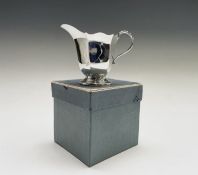 A silver cream jug, 3.1oz, London 1939 together with an epns collectors bell Condition: In good used