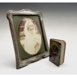 A silver-mounted George V photograph frame by S Lesser & Sons Ltd Birmingham 1927 23x17.5cm and an