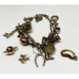 A 9ct gold charm bracelet with some 19 charms together with three loose charms. Total weight 24.6gm.