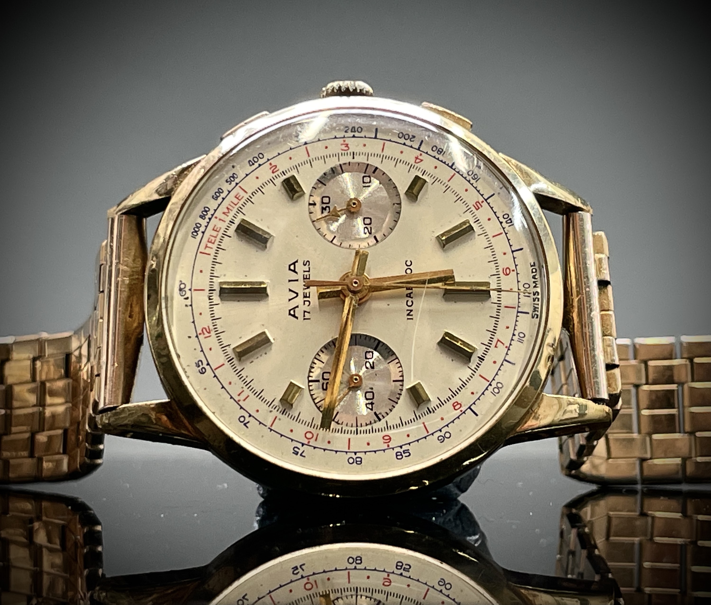 An Avia 9ct gold cased chronograph wristwatch 36mm diameter 52.8gm including gilt bracelet.