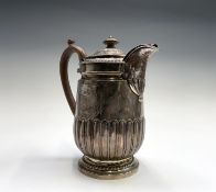 A George III hot water jug by Rebecca Emes & Edward Barnard I with half fluted body and gadrooned