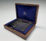 Twelve Old English pattern silver dessert spoons, in a blue silk lined Mappin & Webb fitted box.