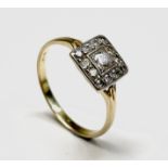 A prettily-set 18ct gold and diamond ring, the central diamond of approximately 0.15ct set in a