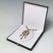 A glamourous Swarovski necklace with fancy gilt metal and white crystal links and an ornate