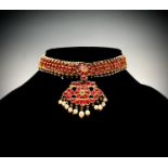 An impressive Ceylonese ruby and pearl necklace, the collar is formed with 68 crescent-shaped