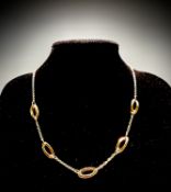 A stylish 18ct gold contemporary necklace of chain interspaced between five elongated,