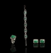 An impressive Mappin and Webb 18ct white gold suite set with emerald cut emeralds and a multitude of