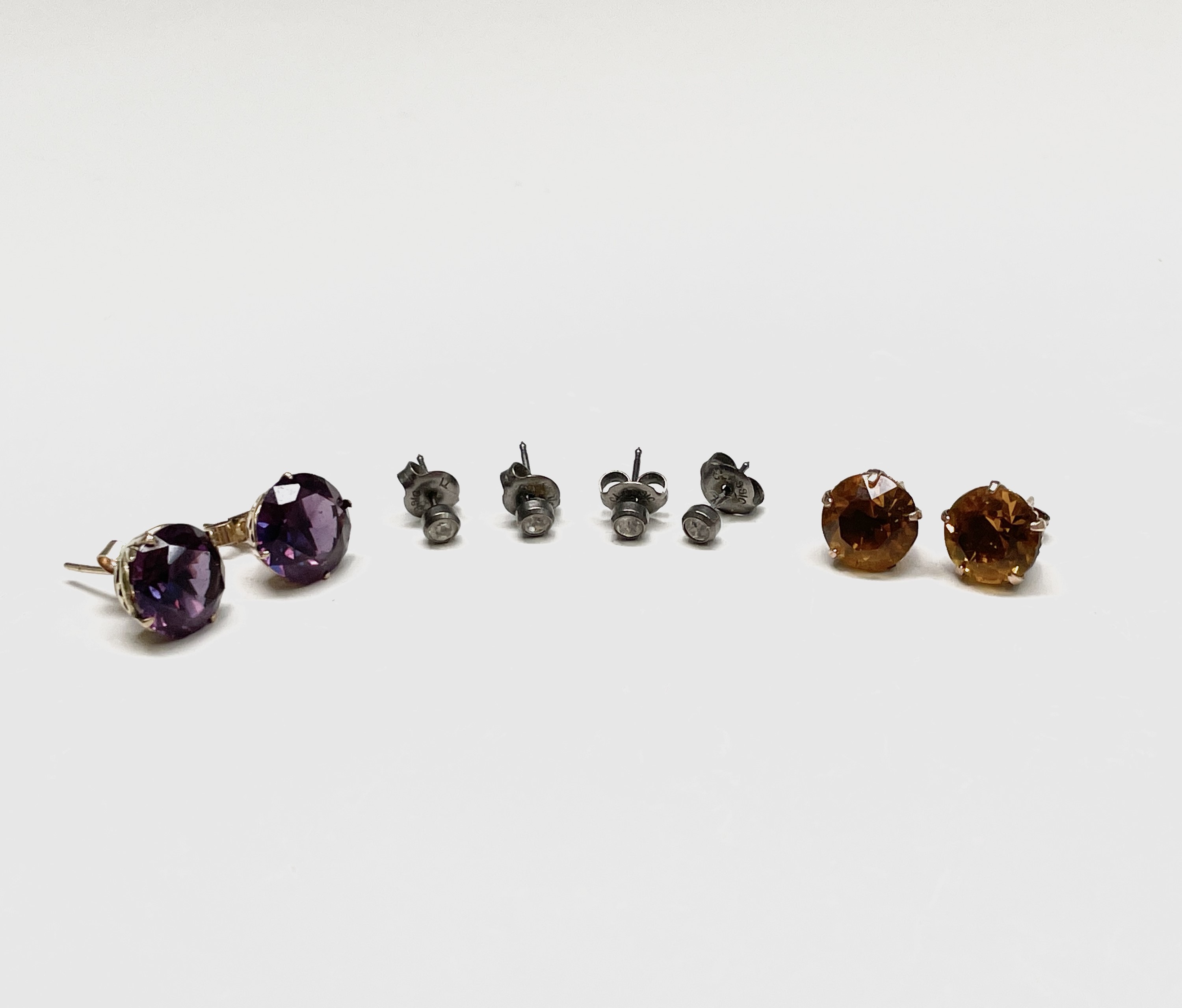 A pair of 9ct gold and amethyst stud earrings together with three other pairs of stud earrings. UK