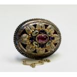 An early Victorian gold brooch set with a central pink gem within other gemstones 40mm 14.6gm