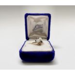 A 10ct gold dress ring set with two pearls and two small intense blue stones, possibly tanzanite.