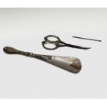 A silver handled shoe horn, London 1912, with a pair of silver handled toilet case scissors,