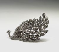 A fabulous and outlandish peacock brooch encrusted with multiple white crystals, total length 11cm.