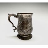 An early George III silver bellied mug by Joseph Steward London 1766, 11.15oz, 12cm. Repouse