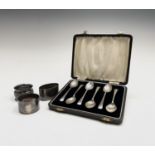 Three silver napkin rings together with a cased set of six silver coffee spoons 5.4oz. Condition: