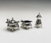 A 1920's Alexander Clark & Co Ltd three-piece silver cruet, 5.2oz, with blue glass liners.